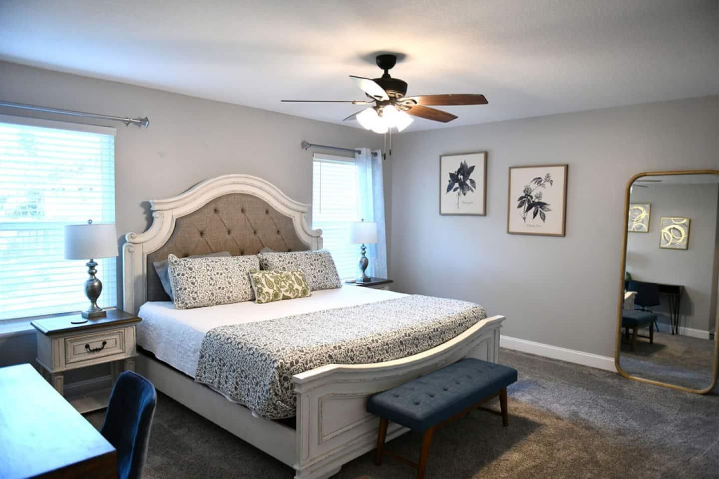 Primary bedroom with a king bed and tufted headboard