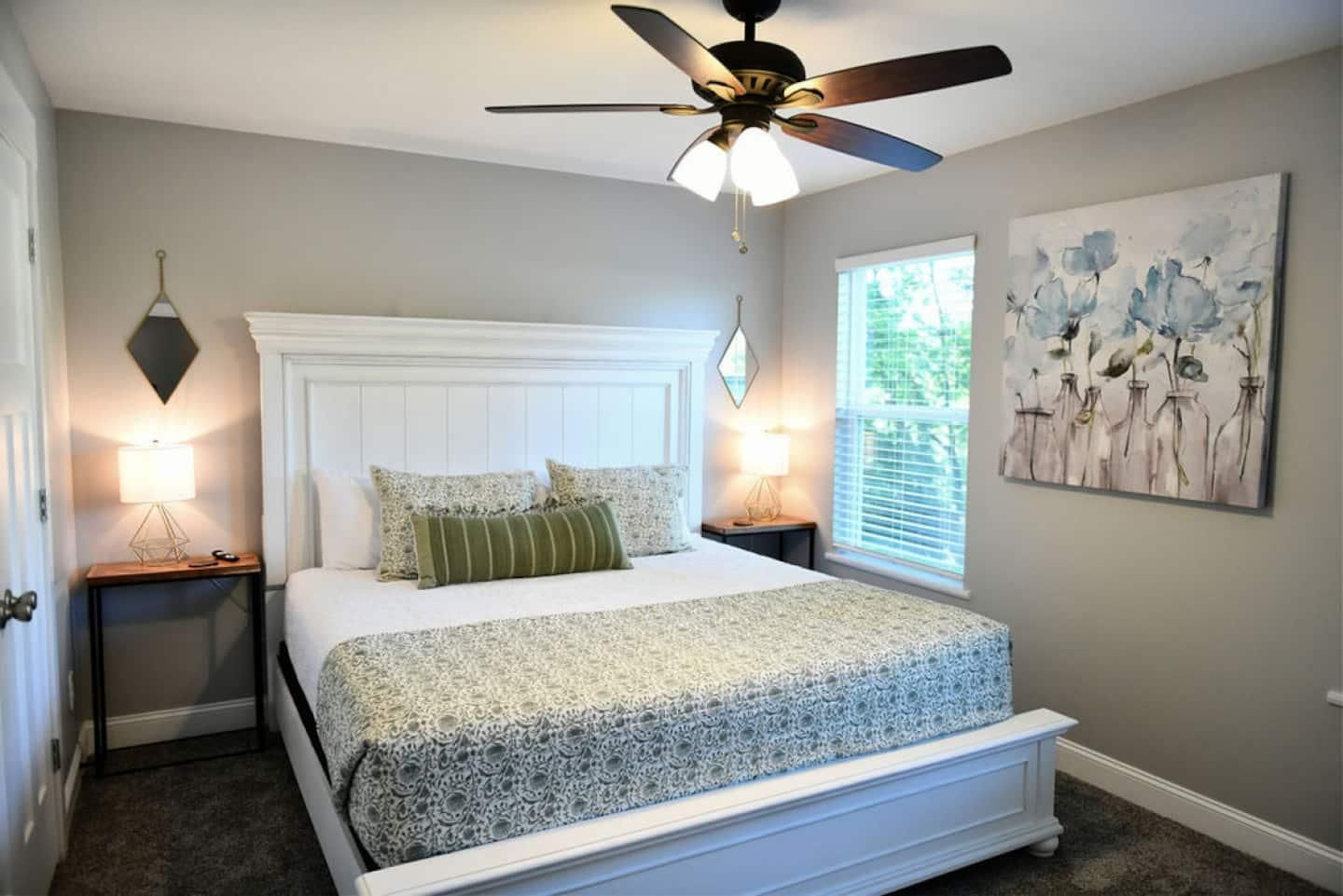 Second bedroom with a white paneled bed