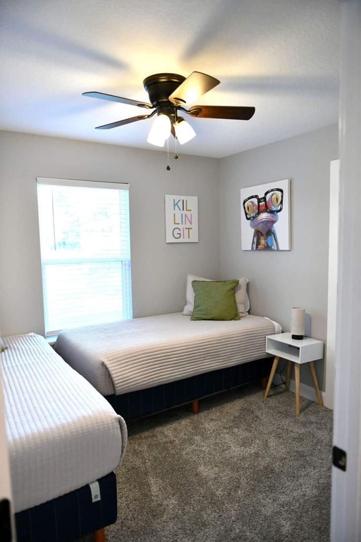 Kids room with single beds and bright art