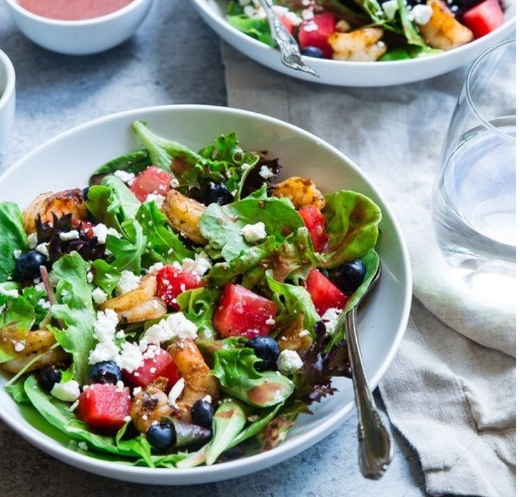 A fresh salad with berries and greens