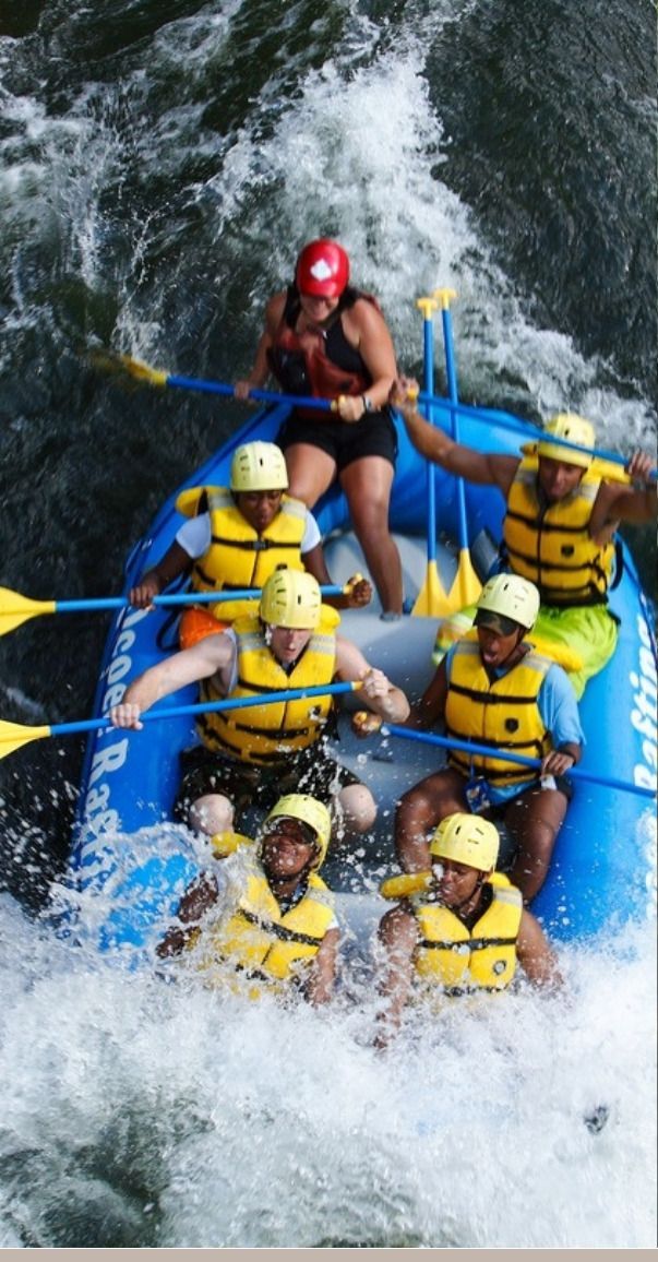 A raft full of paddlers crashing through whitewater